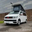 Front driver side view of VW T6 with poptop up.