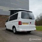 Rear passenger side view of VW T6 with poptop up.