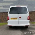 Straight rear view of VW T6 with poptop down.