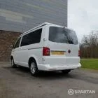 Rear passenger side view of VW T6 with poptop down.