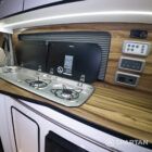 Copper Bronze VW T6.1 LWB campervan showing the Interior - Sink & Hob