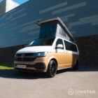 Copper Bronze VW T6.1 LWB campervan showing the front/passenger quarter poptop up