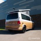 Copper Bronze VW T6.1 LWB campervan showing the rear driver quarter poptop up