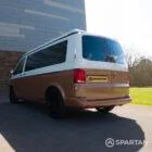 Copper Bronze VW T6.1 LWB campervan showing the rear/passenger quarter poptop down