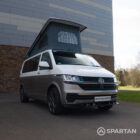 Squirrel Grey VW T6 SWB campervan showing the front driver quarter poptop up