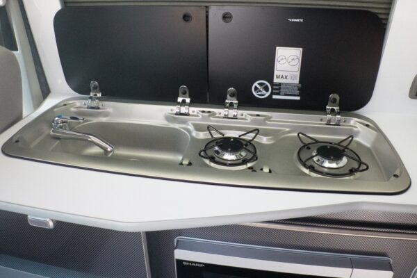 Compact sink and hob built into the Carbon-effect kitchen counter