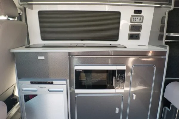 Campervan kitchen featuring Blizzard cabinetry and Carbon worktop