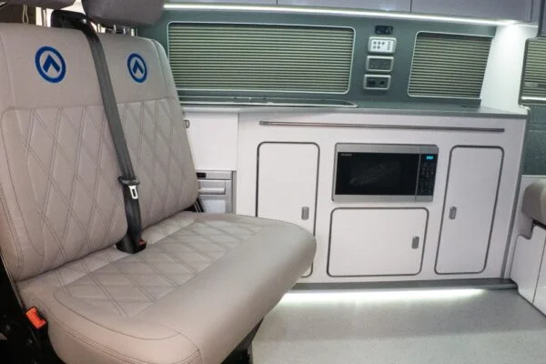 Dusk grey SPARTAN bench seat with precision blue stitching, shown swiveled forward