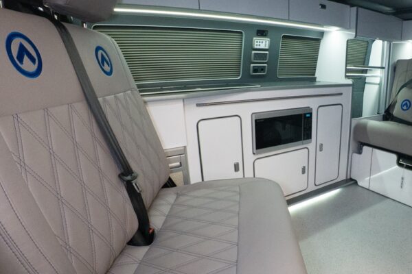 Dusk grey SPARTAN bench seat with precision blue stitching, shown swivelled backwards