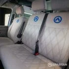 Dusk grey SPARTAN bench seat with precision blue stitching, shown swivelled forward