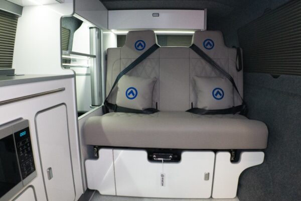 Rock and roll bed in seating position with dusk grey upholstery and blue stitching detail