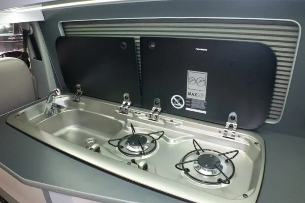 Steel sink with folding tap surrounded by matching steel splashback VW T6.1 LWB