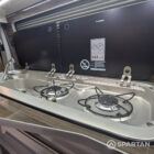 Integrated sink and hob set in latte kitchen on winter floor in VW T6.1 SWB campervan