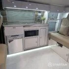 VW T6.1 SWB campervan kitchen interior with winter flooring, latte units and pear gloss accents