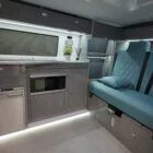 Comfortable interior seating area of a Spartan Campers VW T6 campervan, featuring premium upholstery and a practical layout for relaxing and dining