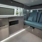 Comfortable interior seating area of a Spartan Campers VW T6 campervan, featuring premium upholstery and a practical layout for relaxing and dining