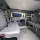 VW T6.1 SWB campervan kitchen interior with grey flooring, steel grey units and white accents