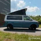 Driver side of a Spartan Campers VW T6 campervan with poptop up, combining everyday practicality with premium camping features