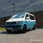 Spartan Campers VW T6 SWB campervan front driver side view with closed poptop, painted in stylish Neptune blue and candy white