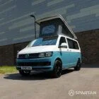 Front passenger side of a Spartan Campers VW T6 campervan with poptop open, designed for adventure and comfort