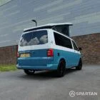 Rear driver side of a Spartan Campers VW Transporter T6 SWB with poptop open and signature two-tone finish