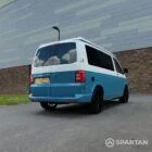 Alt Text: Spartan Campers VW T6 SWB campervan rear driver side view with poptop roof closed, showcasing premium two-tone exterior