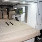 Spartan rock and roll bed upholstered in luxurious Ecru with detailed diamond stitching