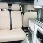 Custom Ecru bench seat with diamond stitching, fitted on a swivel base by Spartan for added versatility