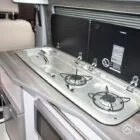 High-quality Spartan kitchen area with stainless steel sink and dual gas hob in a compact layout