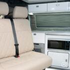 Custom Ecru bench seat with diamond stitching, fitted on a swivel base by Spartan for added versatility