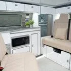 Spartan campervan kitchen featuring white units and silver birch worktops, expertly crafted for style and function