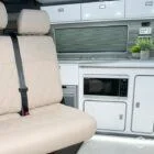 Spartan campervan kitchen featuring white units and silver birch worktops, expertly crafted for style and function