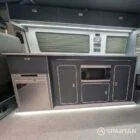 VW T6.1 LWB campervan kitchen interior with blizzard flooring, storm cloud grey units and white accents
