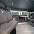 Wide interior view of VW T6.1 LWB campervan with blizzard floor, grey and white units and pewter upholstery