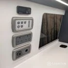 Control panel and wireless phone charger in VW T6.1 LWB campervan with grey and white units