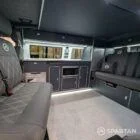 Close-up of storm cloud grey kitchen units with white detail in VW T6.1 LWB campervan