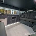 Close-up of storm cloud grey kitchen units with white detail in VW T6.1 LWB campervan
