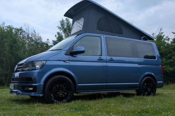 Spartan Campers VW T6 SWB campervan conversion in Acapulco Blue with pop-top roof raised, passenger side view
