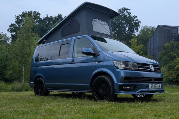 Spartan Campers VW T6 SWB campervan conversion in Acapulco Blue with pop-top roof raised, driver side view
