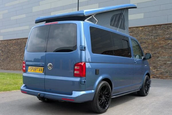 Spartan Campers VW T6 SWB campervan conversion in Acapulco Blue with pop-top roof raised, rear driver quarter view