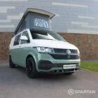 Front passenger quarter view of sage green VW T6.1 Spartan camper with poptop up