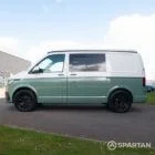 Full passenger side profile of sage green VW T6.1 LWB Spartan camper with roof closed