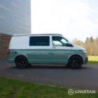 Driver side profile shot of Spartan VW T6.1 campervan in sage green with poptop down