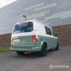 Rear driver quarter angle of a Spartan-converted sage green VW T6.1 camper with poptop closed