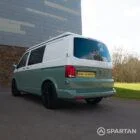 Rear passenger quarter view of a VW T6.1 LWB Spartan campervan in sage green with the poptop roof down