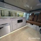 Close-up of VW T6.1 LWB campervan kitchen showing integrated hob and Winchester Oak splashback