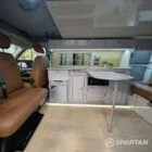 Passenger side view of VW T6.1 LWB campervan with roof down, Military Green and Candy White
