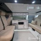 Full interior view of VW T6.1 SWB campervan with winter flooring, white and silver birch kitchen, and ecru upholstery