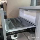 Close-up of white kitchen units with silver birch detail in VW T6.1 SWB campervan