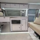 VW T6.1 SWB campervan kitchen interior with winter flooring, white units and silver birch accents